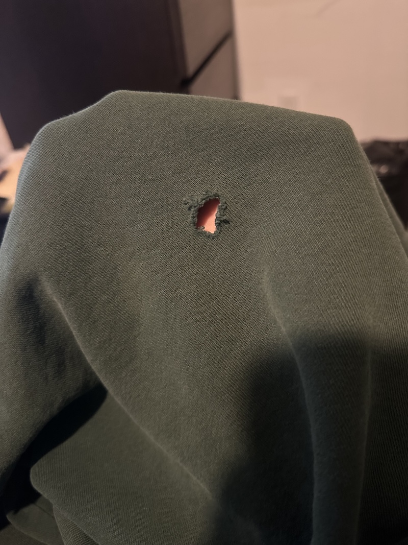Worn sweatshirt before repair