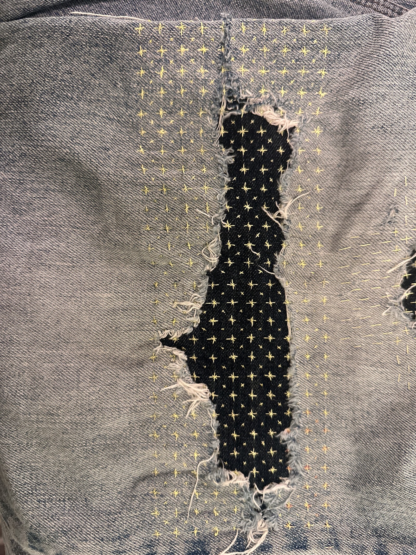 Worn jeans knee before the second repair
